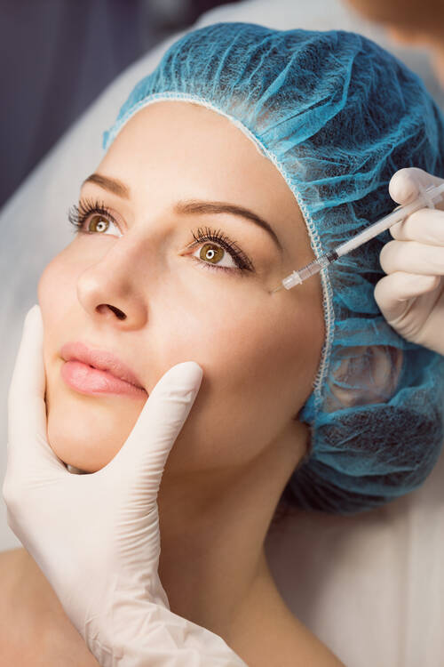 Female patient receiving injection her face